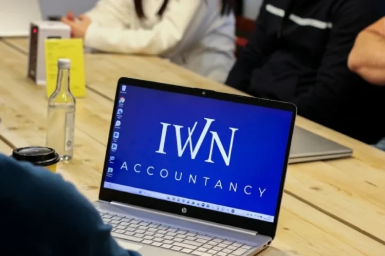 IWN accountancy screensaver on laptop at accountant meeting